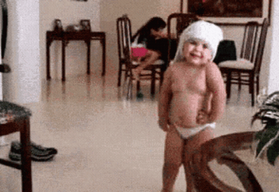 Shirtless Girl With Towel On Head In Living Room GIF