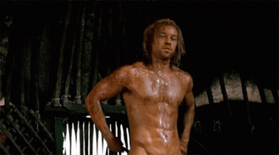 Shirtless Long-Haired Man Standing In Dark Room GIF