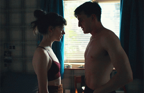 Shirtless Man and Woman Looking at Each Other