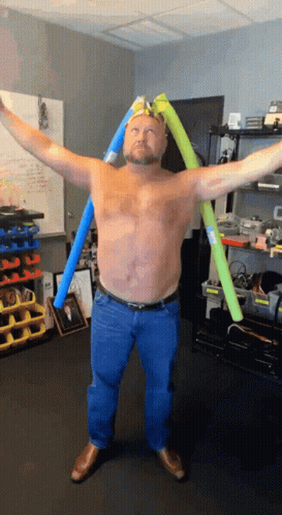 Shirtless Man Arms Outstretched With Man Picture Behind GIF