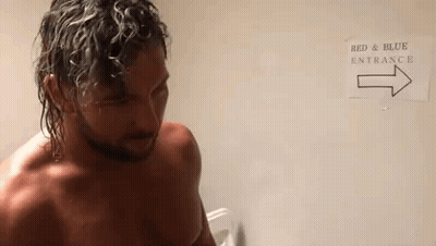 Shirtless Man At Red And Blue Entrance Sign GIF