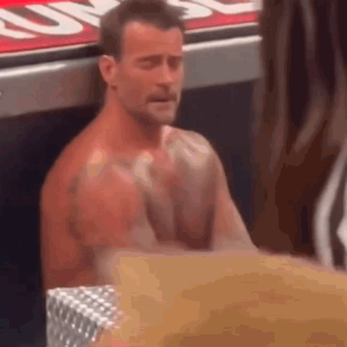 Shirtless Man At Table With Hands Folded In Prayer GIF
