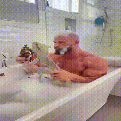 Shirtless Man Bathing With Parrot GIF