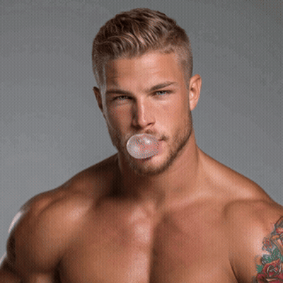 Shirtless Man Blowing Bubble With Shoulder Tattoo GIF