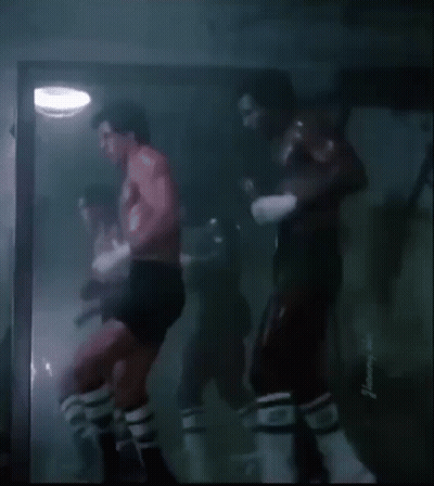 Shirtless Man Boxing In Dark Room GIF
