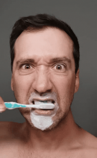 Shirtless Man Brushing Teeth