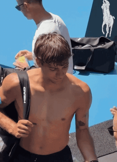 Shirtless Man Carrying Black Head Bag GIF