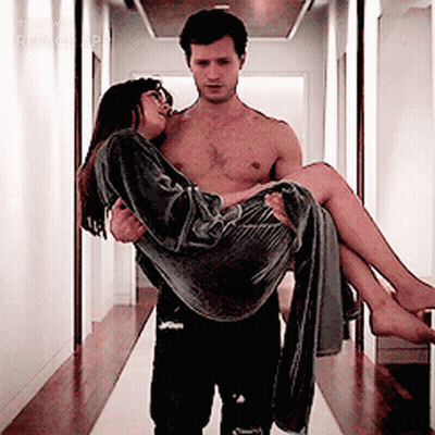 Shirtless Man Carrying Woman In Hallway GIF