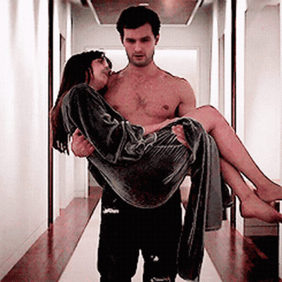 Shirtless Man Carrying Woman In Hallway GIF