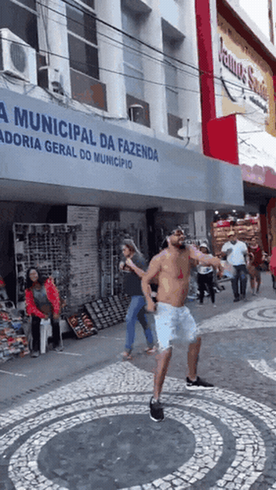 Shirtless Man Dancing In Front Of Municipal Da Fazenda Building GIF
