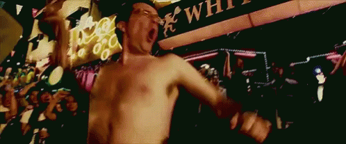 Shirtless Man Dancing In Front Of White Sign GIF