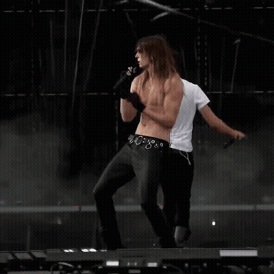 Shirtless Man Dancing On Stage With Microphone GIF