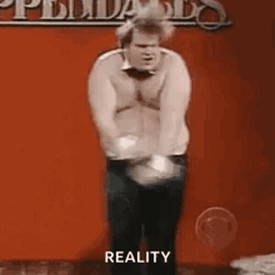 Shirtless Man Dancing On Stage With Reality Sign GIF