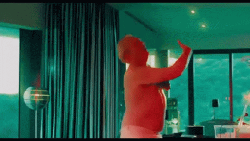 Shirtless Man Dancing With Green Curtain GIF