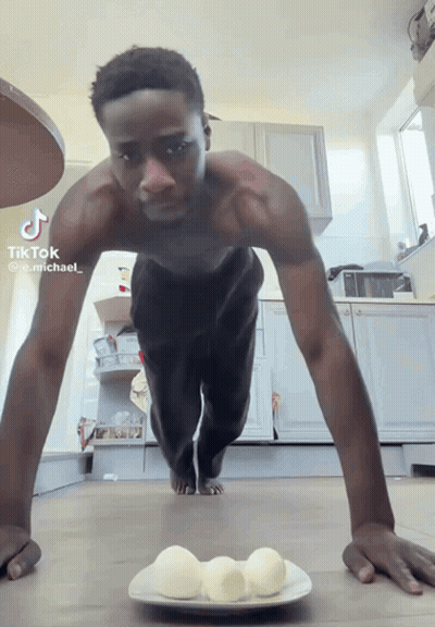 Shirtless Man Doing Push Ups Beside Plate Of Eggs GIF