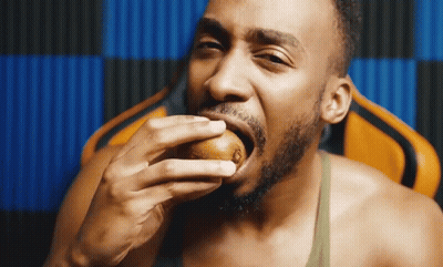 Shirtless Man Eating Kiwi GIF