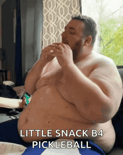 Shirtless Man Eating Pickleball On Couch GIF