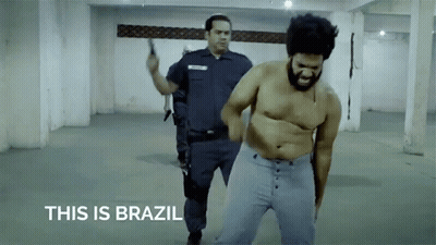 Shirtless Man Escorted By Police Officer This Is Brazil GIF