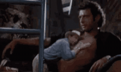 Shirtless Man Holding Baby On Bed GIF