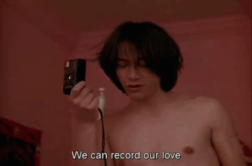 Shirtless Man Holding Camera Says We Can Record Our Love GIF