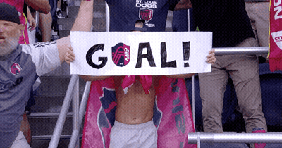 Shirtless Man Holding Goal Sign GIF