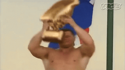 Shirtless Man Holding Gold Trophy GIF