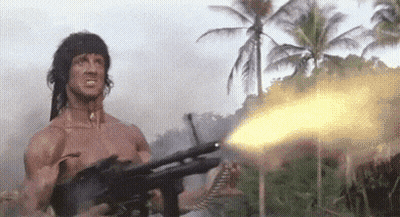 Shirtless Man Holding Gun In Jungle GIF