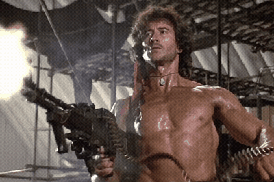 Shirtless Man Holding Machine Gun GIF