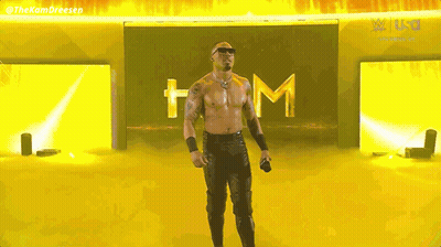 Shirtless Man Holding Microphone By Yellow Wall GIF