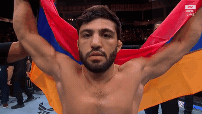 Shirtless Man Holding Multicolored Flag GIF