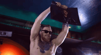 Shirtless Man Holding Picture In Front Of Blin Sign GIF