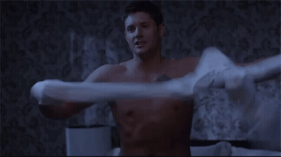 Shirtless Man Holding Pillow Over Head On Bed GIF