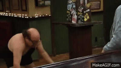 Shirtless Man Holding Trash Can In Restaurant GIF