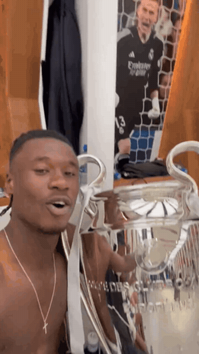 Shirtless Man Holding Trophy In Locker Room GIF