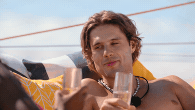 Shirtless Man Holding Two Glasses Of Champagne GIF