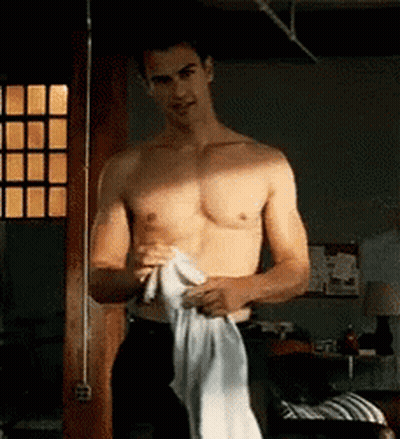 Shirtless Man Holding White Shirt By Window GIF