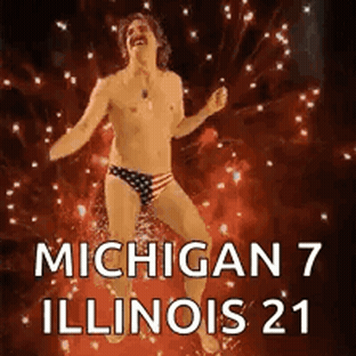 Shirtless Man In Bathing Suit Dancing In Front Of Fireworks GIF