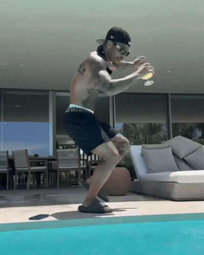 Shirtless Man In Black Shorts Jumping Into Pool GIF