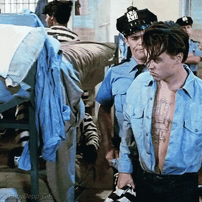 Shirtless Man In Blue Escorted By Police GIF
