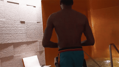 Shirtless Man In Blue Shorts By Pool GIF