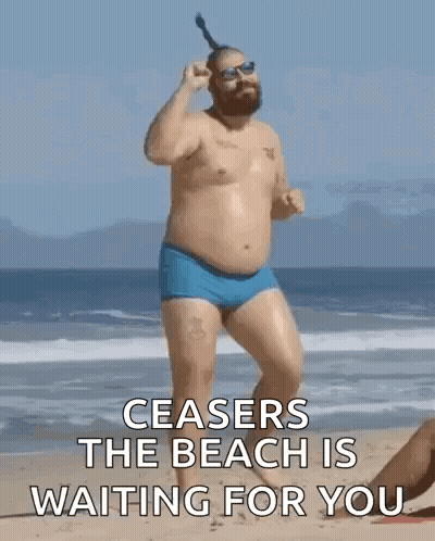 Shirtless Man In Blue Swim Trunks On Beach GIF