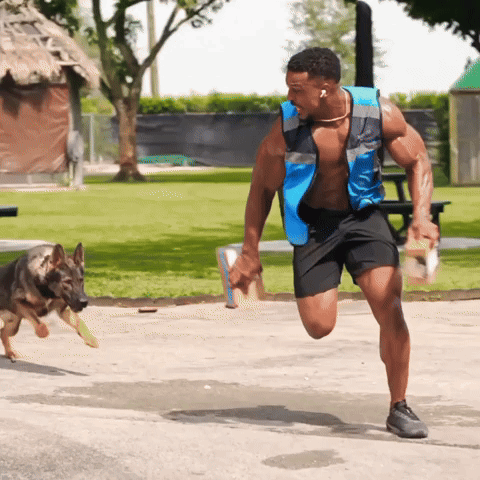 Shirtless Man In Blue Vest Running With Dog GIF