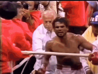 Shirtless Man In Boxing Ring Surrounded By People GIF