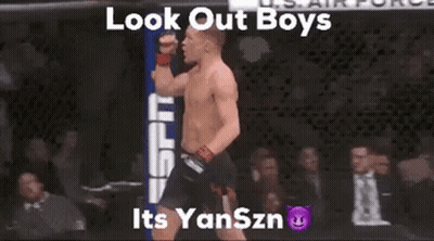 Shirtless Man In Cage With Fist Up Saying Look Out Boys Its Yanszn GIF