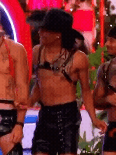 Shirtless Man In Cowboy Hat, Leather Shorts With Group GIF