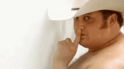 Shirtless Man in Cowboy Hat Shushing