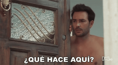 Shirtless Man In Front Of Door Saying Que Hace Aqui GIF
