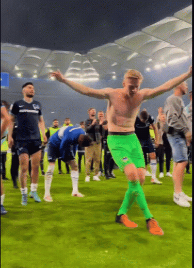 Shirtless Man In Green Shorts Dancing On Field GIF