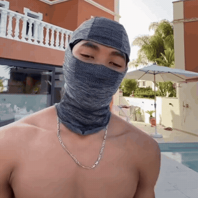 Shirtless Man In Grey Balaclava And Silver Chain GIF