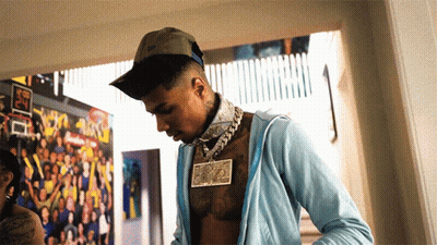 Shirtless Man In Hat And Blue Jacket With Dollar Bill Necklace GIF